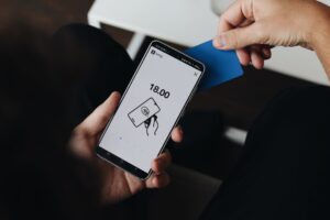 A person holding a cell phone in their hand
